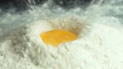 Egg Yolk Falling on Flour Stock Footage 122741666