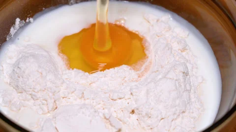 Egg yolk falling into flour Stock Footage 247637280