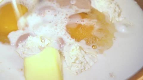 Egg yolk falling into flour Stock Footage 254167090