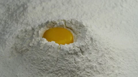 Egg Yolk Falling on Flour in Slow Motion Stock Footage 137867881