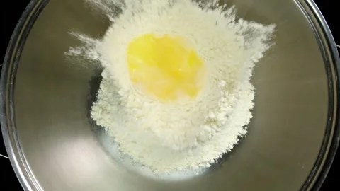 Egg Yolk Falling into Flour in Slow Motion Stock Footage 314894174
