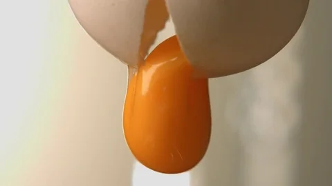 Egg yolk falls on a hill of wheat flour. Stock Footage 83723342