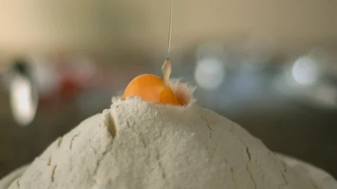 Egg yolk falls on a hill of wheat flour. Stock Footage 83723593