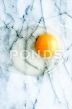 Egg yolk on marble - recipe ingredients and homemade cooking concept Stock Photos