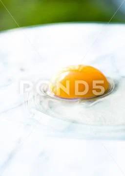 Egg yolk on marble - recipe ingredients and homemade cooking concept Stock Photos