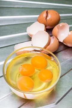 Egg Yolks in a bowl with egg shells as the background Stock Photos