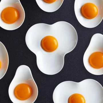 Egg yolks on a plate. Broken eggs close-up. Smooth, shiny membrane on the yolk Stock Photos
