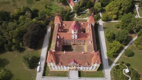 Eggenberg Palace from a top down view pulling back to the front facade Stock Footage 344645626