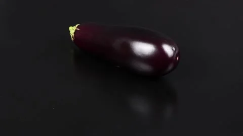 Eggplant on Black. Extrem close-up. Top view. Loop motion. Stock Footage 163877807