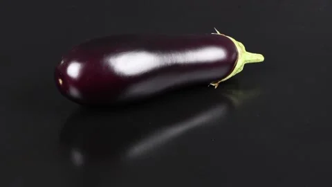 Eggplant on Black. Side view. 4K UHD video footage. Stock Footage 163877169