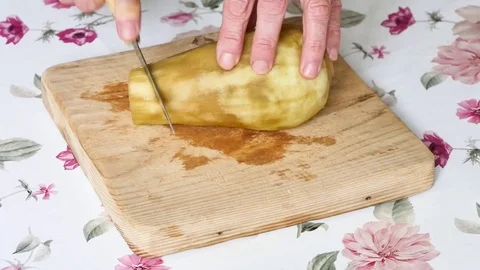 An eggplant is cut in slow motion. Stock Footage 94970058