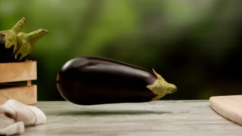 Eggplant falling in slow motion over table Stock Footage 156752481