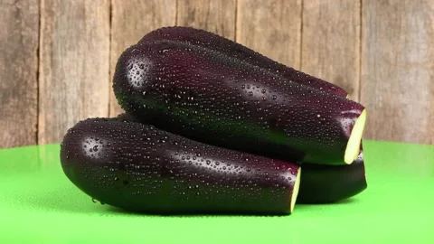 Eggplant on green background. Side view. Loop motion. Stock Footage 163885302