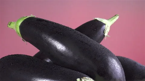 Eggplant isolated rotating on red/pink background Stock Footage 62368315