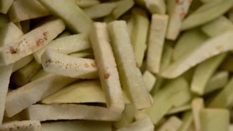 Eggplant Julienne Strips Spinning on Dark Surface. Top-Down Seamless Vegetable 스톡 동영상 326242501