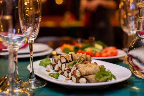 Eggplant rolls on a served table Stock Photos