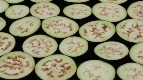 Eggplant slices on Black. Side view. Loop motion. Stock Footage 163881848