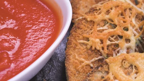 Eggplant Slices Breaded with Tomato Sauce on Black Plate Over Wood Video stock 128163092