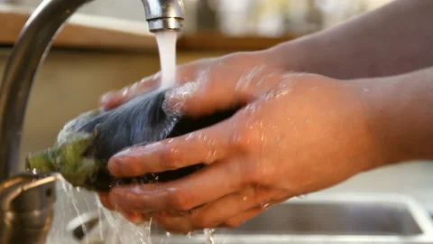 Eggplant under running water Stock Footage 87037435