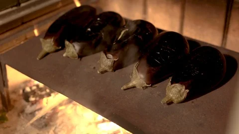 Eggplants over burning fire Stock Footage 85938278