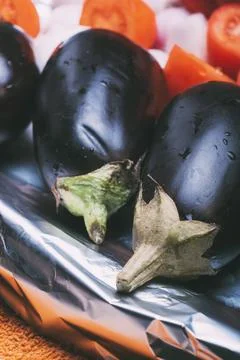 Eggplants prepared to cook them on a baking tray. Stock Photos