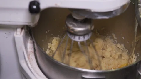 Eggs added to cookie dough machine, slow motion 1080p Stock Footage 126143706