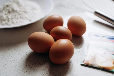 Eggs and Baking Ingredients on Kitchen Counter Stock Photos