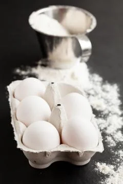 Eggs and cup of flour Foto stock