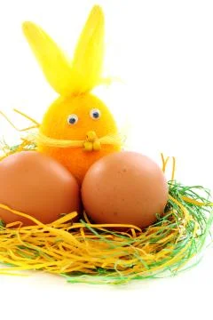Eggs and the easter bunny in the nest. Stock Photos