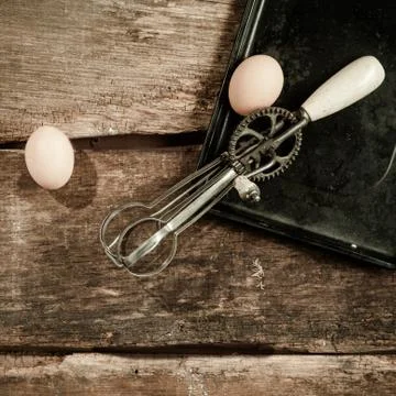 Eggs and an egg beater Stock Photos