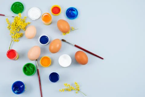 Eggs and paints. Easter eggs decoration process. Copy space. Top view. Stock Photos