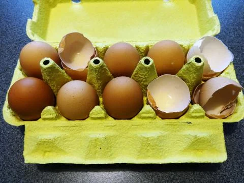 Eggs and shells in a paper wrapper Stock Photos