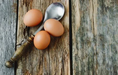 Eggs and spoon Stock Photos