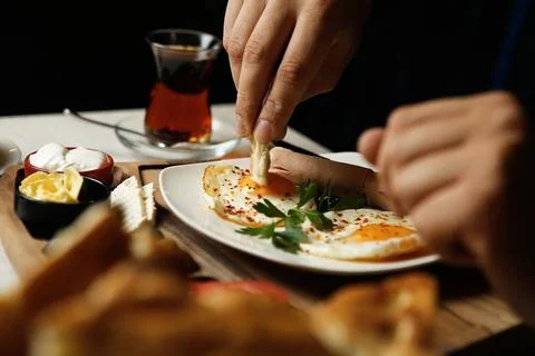 Eggs and tea served on a table during breakfast in a cafe environment Stock Photos