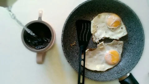 Eggs and tea on white table Stock Footage 82770691