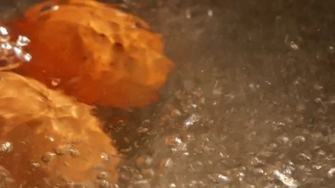 Eggs are being hard-boiled with boiling water in a pan. Stock Footage 262939521