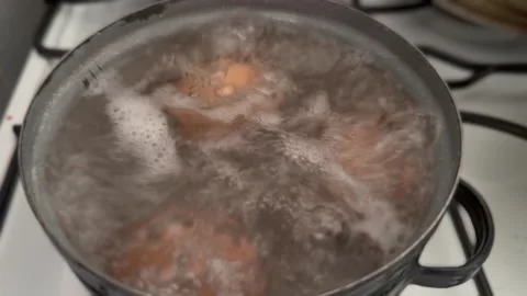 Eggs Are Boiled In A Black Old Pot In Hot Water With Bubbles Stock Footage 274138892