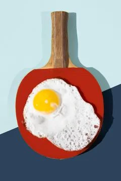 The eggs are laid on a plate in the shape of a red tennis racket. Stock Photos