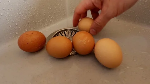 Eggs are washed in the sink to prepare for painting on Easter. Stock Footage 128123613