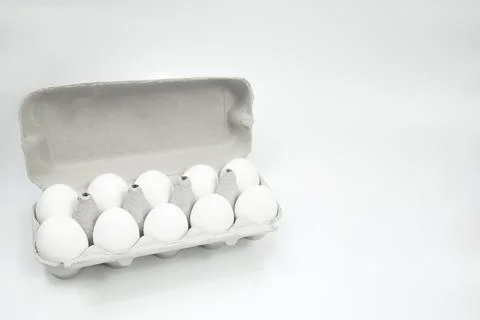 Eggs are white in a box on a white background. Place for text. Copy spase Stock Photos