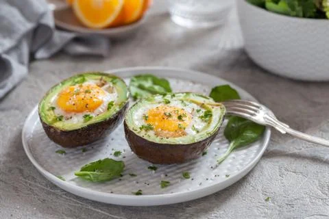 Eggs baked in avocado Stock Photos