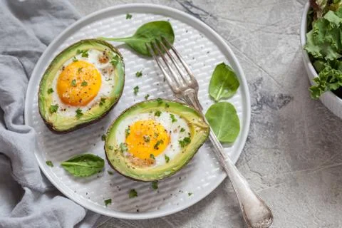 Eggs baked in avocado Stock Photos