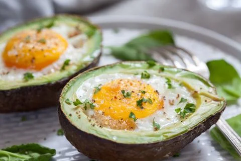 Eggs baked in avocado Stock Photos