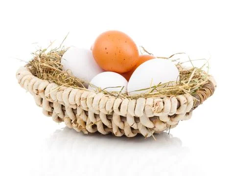 Eggs in basket isolated on white background Stock Photos