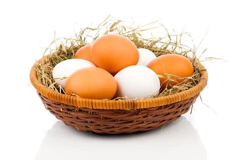 Eggs in basket isolated on white background Stock Photos