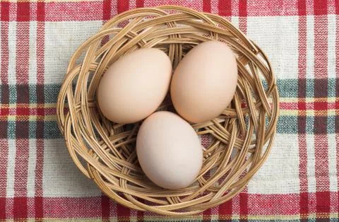 Eggs in basket Stock Photos