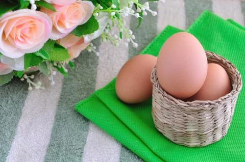 Eggs on basket Stock Photos