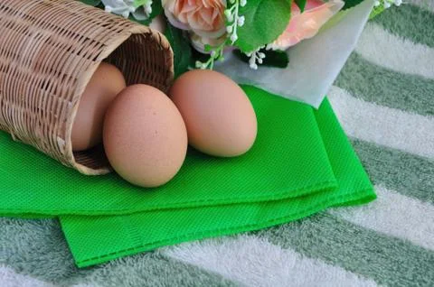 Eggs on basket Stock Photos