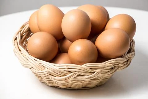 Eggs in basket Stock Photos