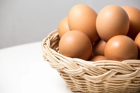Eggs in basket Stock Photos